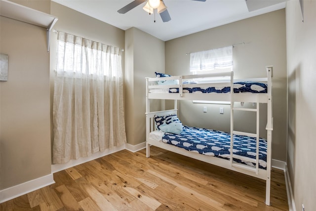 bedroom with ceiling fan and hardwood / wood-style floors