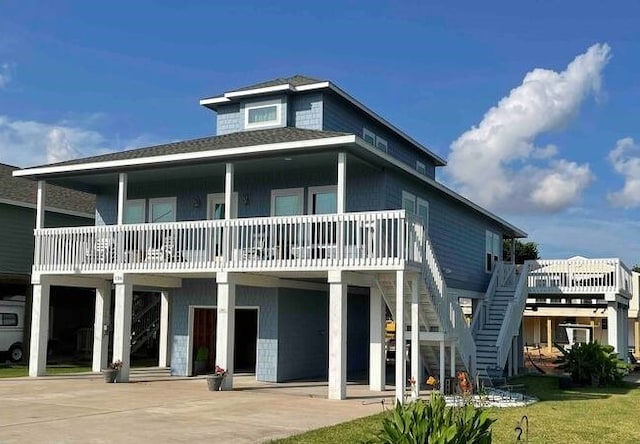 back of house featuring a carport