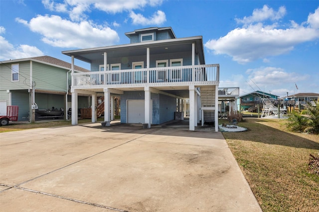 view of front facade featuring a carport, a garage, a porch, a balcony, and a front yard