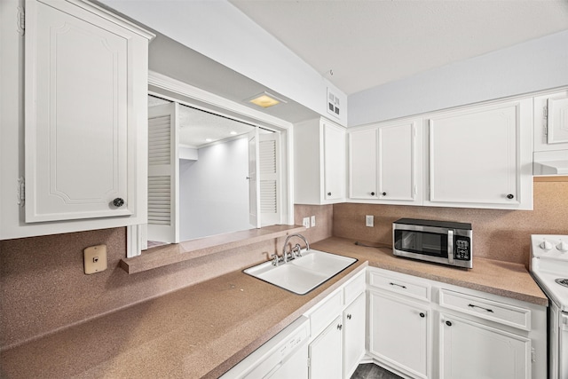 kitchen with white cabinetry, sink, white appliances, and decorative backsplash