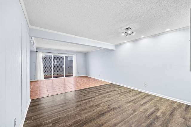 spare room with crown molding, wood-type flooring, and a textured ceiling