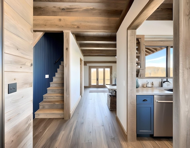 interior space with sink, beam ceiling, and wood-type flooring