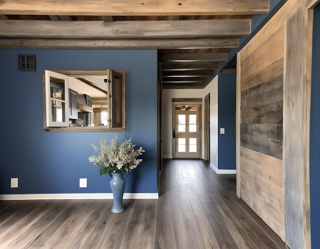 foyer with beamed ceiling and dark wood-type flooring