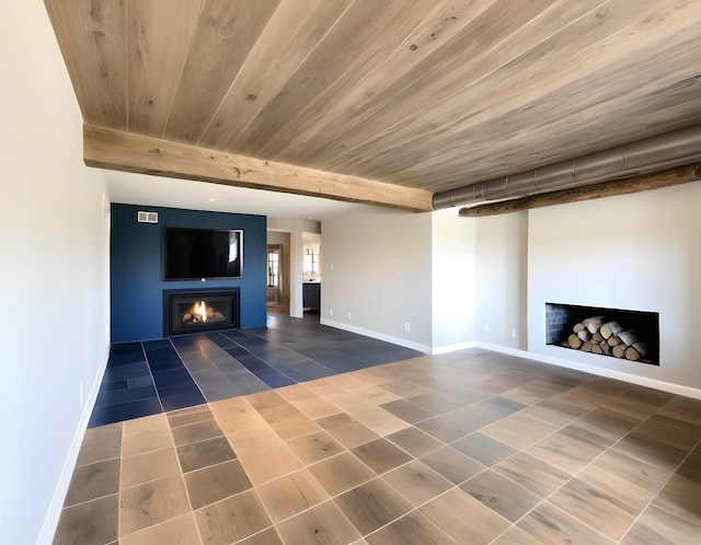 unfurnished living room featuring wood ceiling, tile patterned floors, and beam ceiling