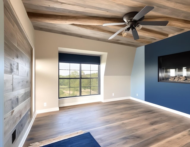 empty room with wood ceiling, wood-type flooring, and ceiling fan