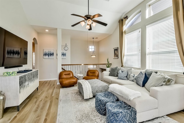 living room featuring ceiling fan, lofted ceiling, and light hardwood / wood-style floors