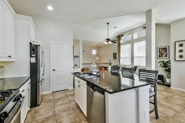 kitchen featuring sink, a breakfast bar, a kitchen island with sink, white cabinetry, and stainless steel appliances