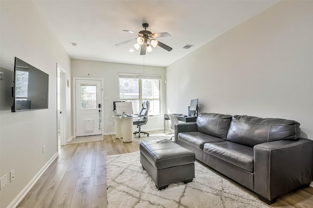 living room featuring ceiling fan and light wood-type flooring