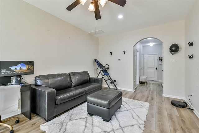 living room with ceiling fan and light wood-type flooring