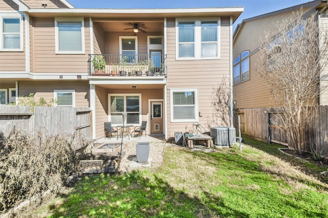 back of property featuring central AC, a balcony, a lawn, ceiling fan, and a patio