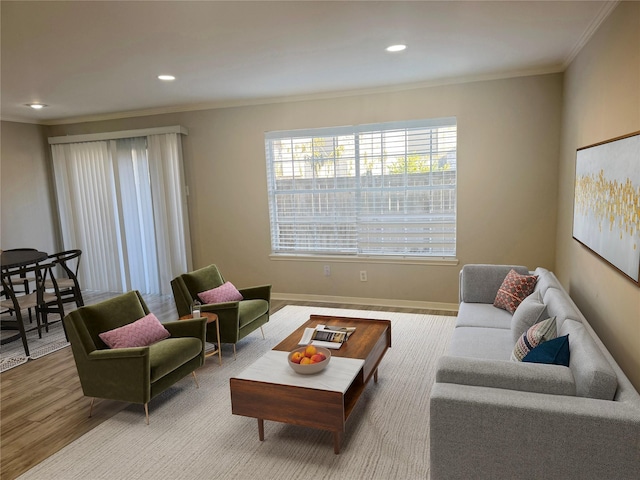 living room featuring hardwood / wood-style flooring and ornamental molding