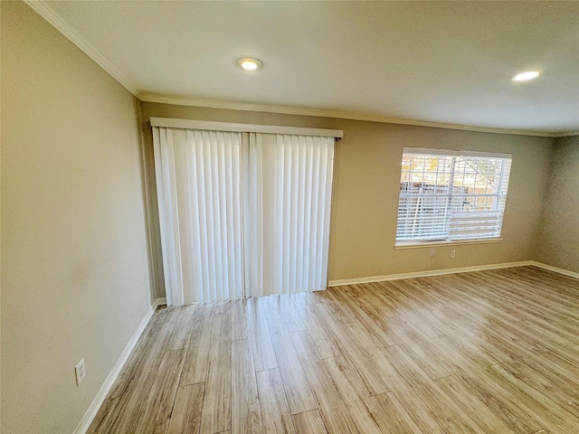 empty room with ornamental molding and light hardwood / wood-style floors