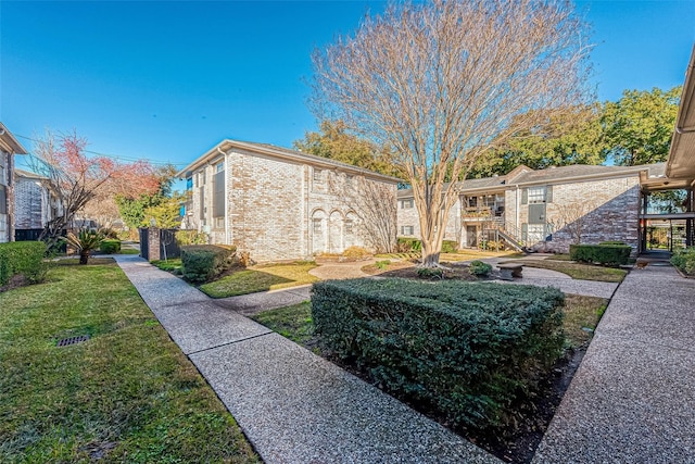 view of side of property with a lawn