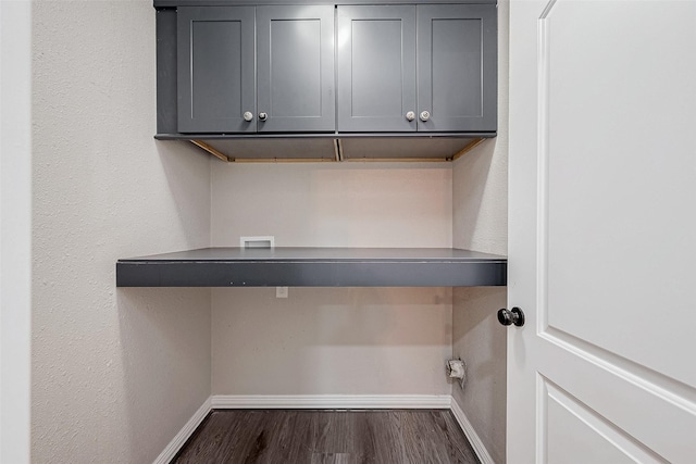 clothes washing area with cabinets and dark hardwood / wood-style flooring