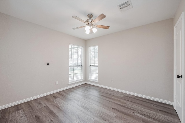 spare room featuring hardwood / wood-style flooring and ceiling fan