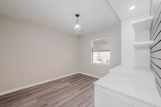 dining area with an inviting chandelier and light hardwood / wood-style floors