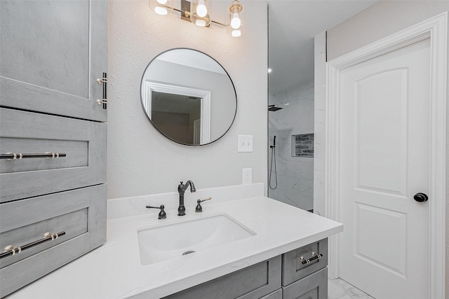 bathroom with vanity and a tile shower