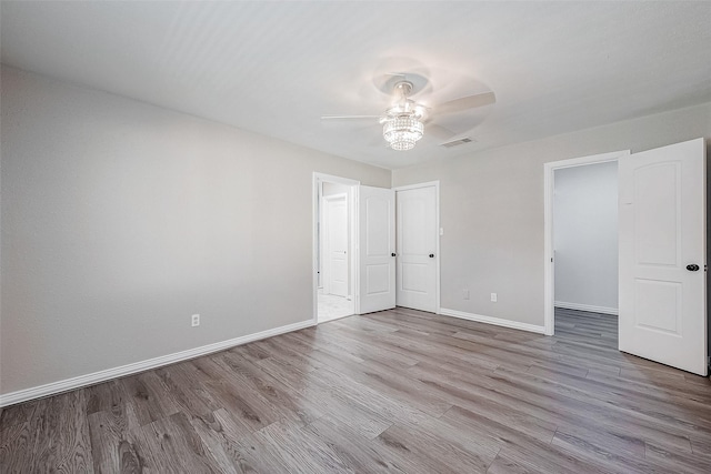 unfurnished bedroom with ceiling fan and light wood-type flooring