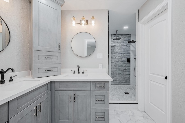 bathroom featuring vanity and tiled shower