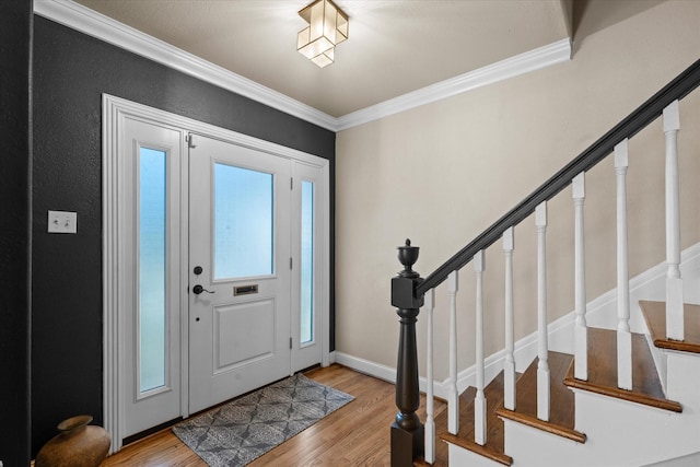 foyer with crown molding and light wood-type flooring