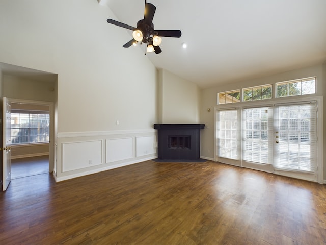 unfurnished living room with ceiling fan, dark hardwood / wood-style floors, and high vaulted ceiling