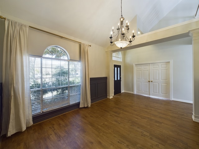 interior space with a notable chandelier, dark wood-type flooring, and high vaulted ceiling