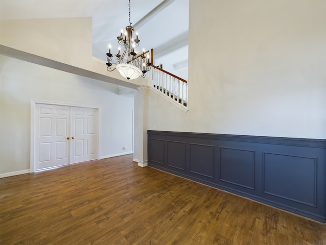 foyer featuring dark hardwood / wood-style flooring, a chandelier, and high vaulted ceiling