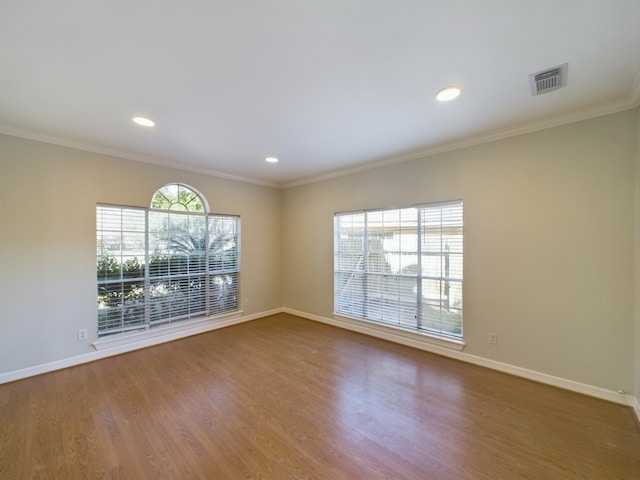 unfurnished room with hardwood / wood-style flooring and ornamental molding