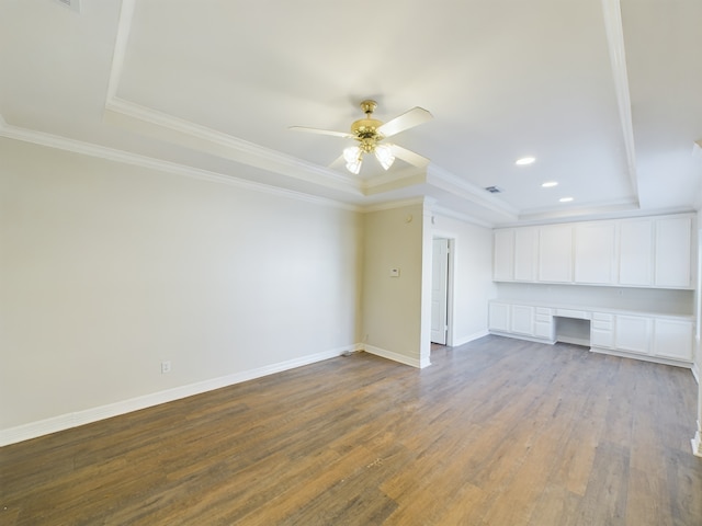 unfurnished living room with crown molding, built in desk, light hardwood / wood-style floors, and ceiling fan