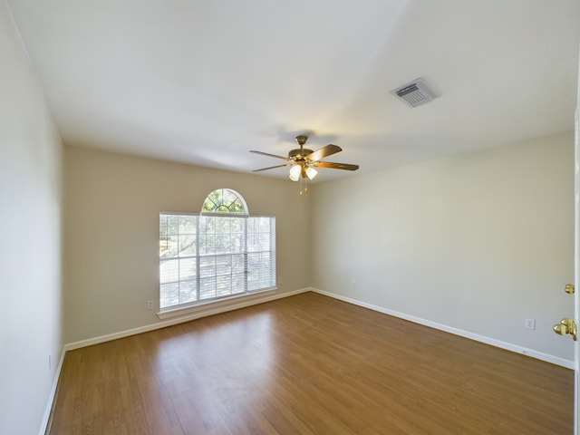 unfurnished room featuring ceiling fan and dark hardwood / wood-style flooring