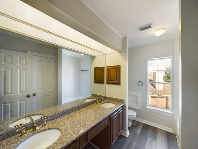 bathroom with hardwood / wood-style flooring, vanity, and toilet