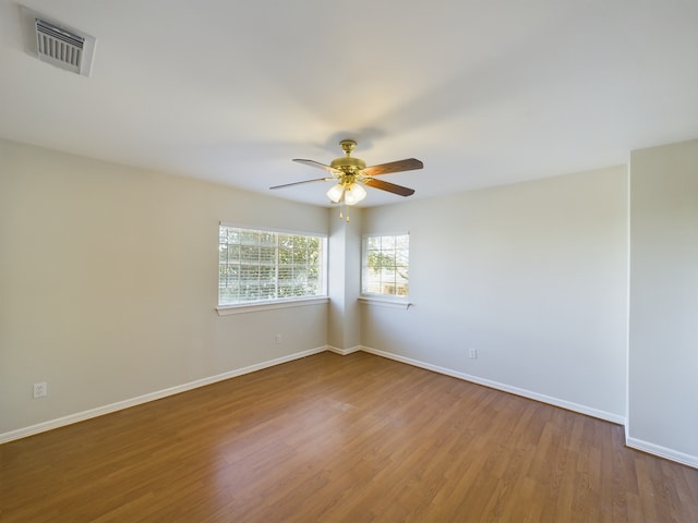 unfurnished room with ceiling fan and wood-type flooring