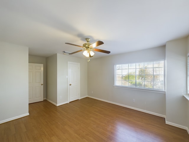 spare room with wood-type flooring and ceiling fan