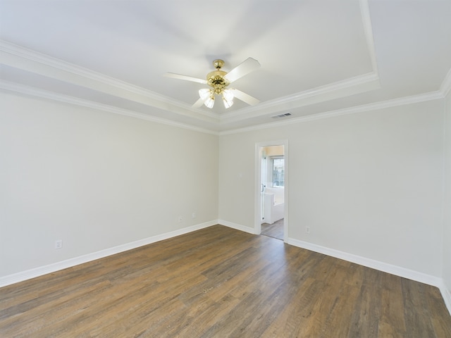 empty room with crown molding, ceiling fan, and dark hardwood / wood-style flooring