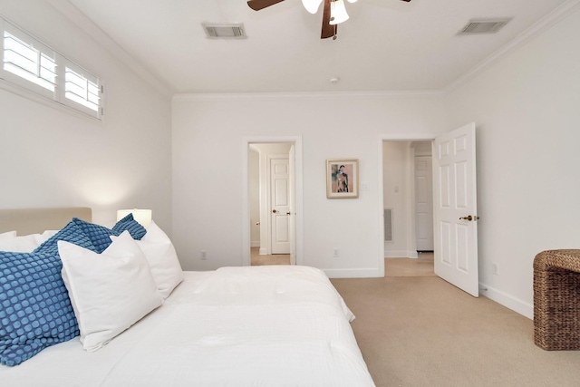 carpeted bedroom with ornamental molding and ceiling fan