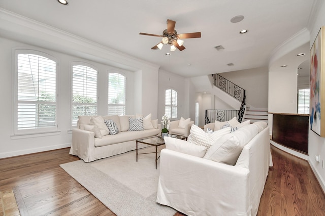 living room with crown molding, ceiling fan, and dark hardwood / wood-style flooring