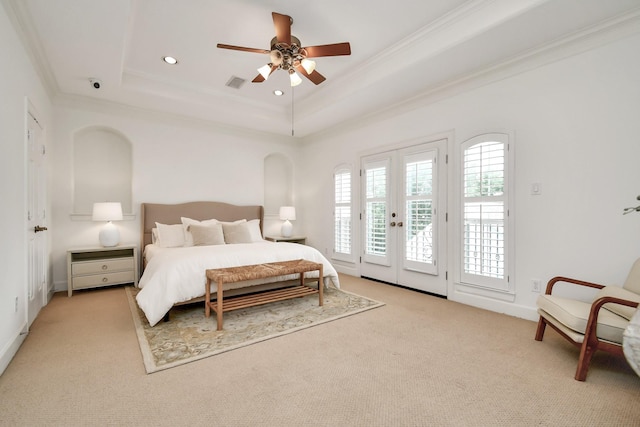 bedroom with access to exterior, a tray ceiling, ornamental molding, light carpet, and french doors