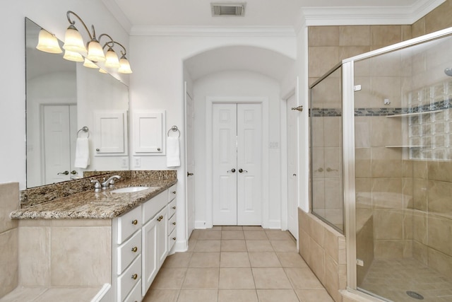 bathroom with a shower with shower door, crown molding, vanity, a notable chandelier, and tile patterned flooring