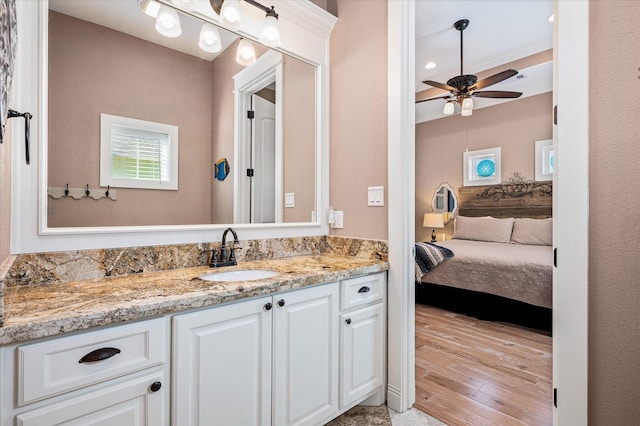 bathroom with hardwood / wood-style flooring, vanity, and ceiling fan