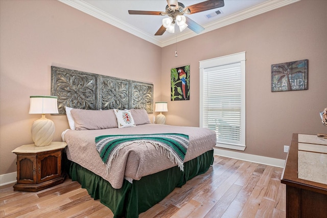 bedroom with crown molding, ceiling fan, and light hardwood / wood-style floors