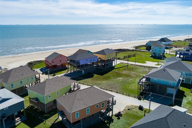 bird's eye view featuring a water view and a beach view