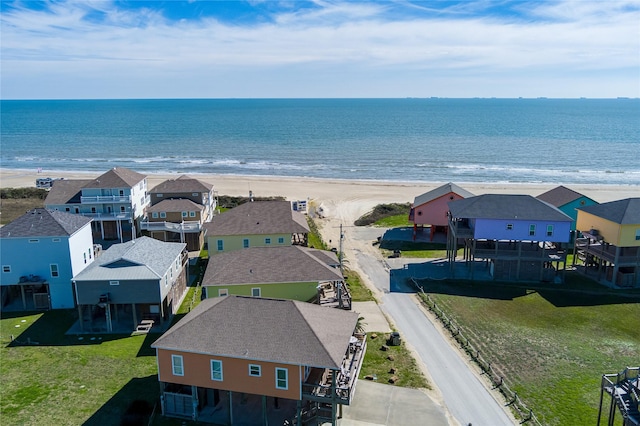 drone / aerial view with a beach view and a water view