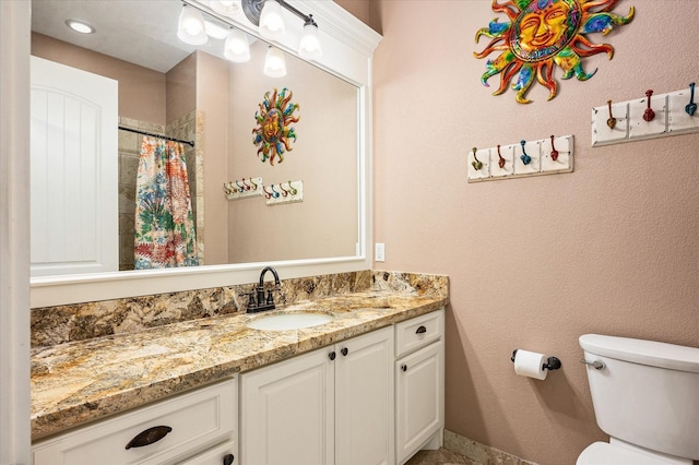 bathroom with vanity, toilet, and a shower with shower curtain