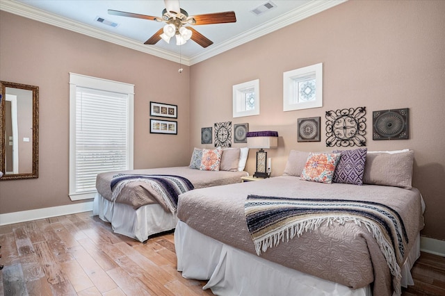 bedroom featuring ceiling fan, ornamental molding, and light wood-type flooring