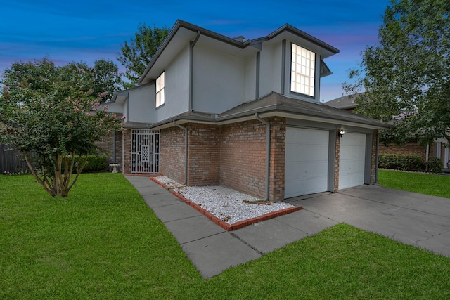 view of front of property with a garage and a lawn