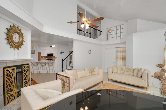 living room featuring high vaulted ceiling and ceiling fan