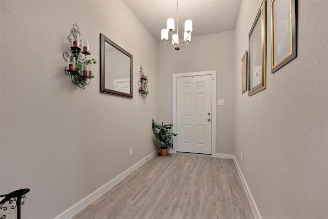 entryway with a notable chandelier and light hardwood / wood-style flooring