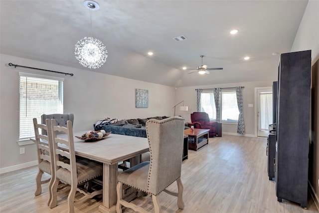 dining space with ceiling fan, lofted ceiling, and light hardwood / wood-style flooring