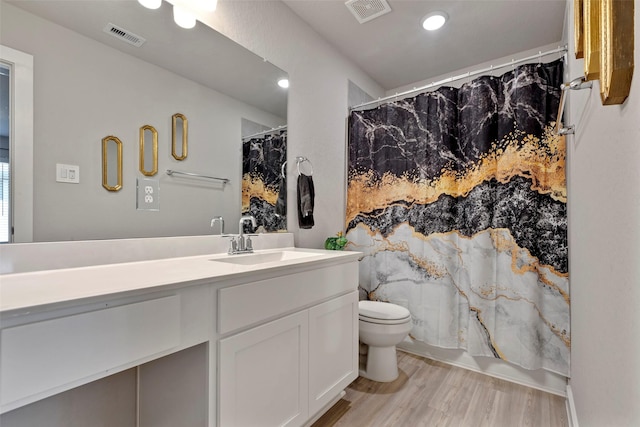 bathroom featuring hardwood / wood-style flooring, vanity, and toilet