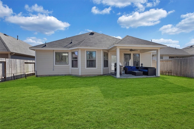 back of property with an outdoor living space, a yard, a patio, and ceiling fan